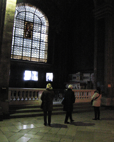 visitors look at the triptych